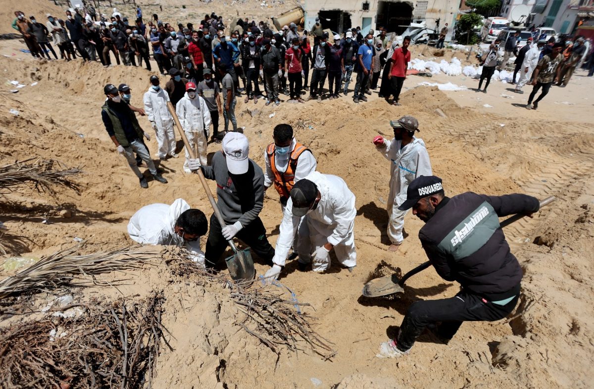 People work to move into a cemetery bodies of Palestinians killed during Israel's military offensive and buried at Nasser hospital, amid the ongoing conflict between Israel and the Palestinian Islamist group Hamas, in Khan Younis in the southern Gaza Strip, April 21, 2024. REUTERS/Ramadan Abed/File Photo