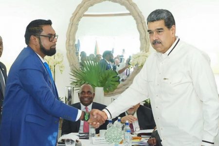 President Irfaan Ali (left) and Venezuelan President Nicolas Maduro shaking hands at one of their meetings that resulted in the signing of Joint Declaration of Argyle for Dialogue and Peace between the two countries in St Vincent in December last year. (Office of the President photo)