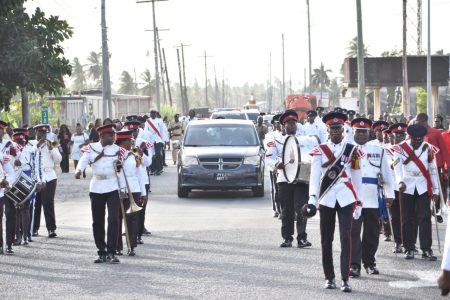  Police Sergeant Alex Robert Vaughn, who was killed by a bullet from a colleague’s gun during the police’s hunt on March 12th, for prison escapee, convicted rapist and suspected murderer Akeem Wong, was yesterday laid to rest at the Helena Number 2 Cemetery, Mahaica, East Coast Demerara. The sergeant was last stationed in Regional Police Division #7 as the Subordinate Officer-in-Charge of the Sherima Police Outpost. Deputy Commissioner ‘Operations’ Ravindradat Budhram, Crime Chief Wendell Blanhum, and Commander Region #7 Superintendent Dion Moore were among current and retired officers and ranks who attended the funeral service at the Living Fountain Ministries Church, East Coast Demerara. In this photograph police ranks are seen in a ceremonial procession for the late officer. (GPF photo)