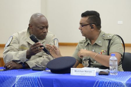 File: Acting Assistant Commissioner of Police, Neil Brandon John, left, speaks with Port-of-Spain Division Area East head, ASP Ramesh Soodeen during a Police Town Meeting at the Belmont Community Centre earlier this month.