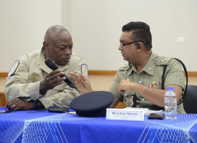 File: Acting Assistant Commissioner of Police, Neil Brandon John, left, speaks with Port-of-Spain Division Area East head, ASP Ramesh Soodeen during a Police Town Meeting at the Belmont Community Centre earlier this month.