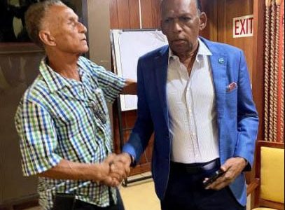 New Jamaica Cricket Association (JCA) president Dr Donovan Bennett (left) is congratulated by outgoing president Wilford ‘Billy’ Heaven following the election of officers at the JCA’s annual general meeting held at the Jamaica Conference Centre yesterday.