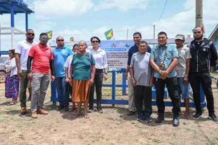 Minister within the Ministry of Housing and Water, Susan Rodrigues along with the residents and technical officers from the Guyana Water Incorporated (GWI) at the commissioning of the Karaudarnau water distribution system
