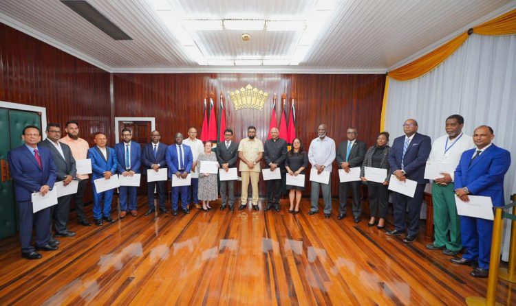 From left are RK Sharma, Imran Ally, Dr Josh Kanhai, Derrick Rowan John, Aslim Singh, Ramesh Persaud, Kwame McCoy,  Dr Frank Anthony, Gail Teixeira, Anil Nandlall SC, President Irfaan Ali, Carl Singh, Pauline Sukhai, Vincent Alexander, Ganesh Mahipaul, Dr Kim Kyte-Thomas, Nigel Hughes, Sherwood Lowe and Adrian Anamayah. (Office of the President photo) 