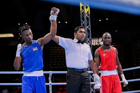 Indonesian referee Kabilan Sai Ashok raises the hand of Louis Colin of Mauritius in victory by way of a
unanimous decision over Guyana’s Joel Williamson