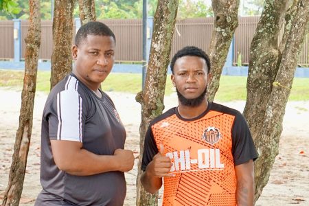 Slingerz FC Coach Alex Thomas (left) poses with new signing Kemar Beckford.