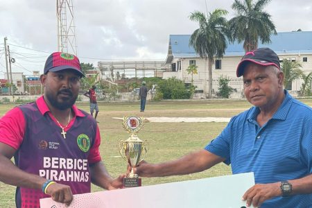 Berbice Piranhas captain Veerasammy Permaul (right) collects his man-of-the-match accolade after snaring 4-24