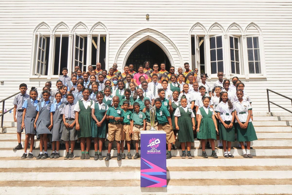 Numerous schoolchildren from several schools pose with the ICC Men’s T20 World Cup trophy at the iconic St. George’s Cathedral yesterday. Also in the photo are several national cricketers.