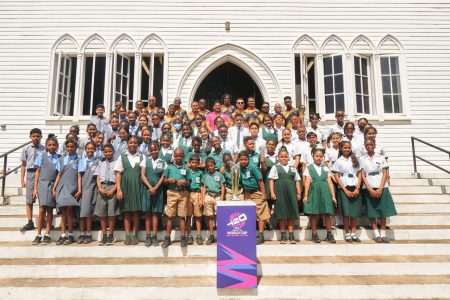 Numerous schoolchildren from several schools pose with the ICC Men’s T20 World Cup trophy at the iconic St. George’s Cathedral yesterday. Also in the photo are several national cricketers.