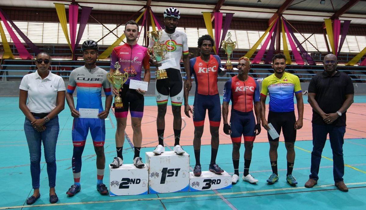 Britton John (centre) displays his spoils at the presentation ceremony at the National Gymnasium, Mandela Avenue, after sweeping the NSC Independence 3-Stage Cycling Road Race. Also in the photo (from left to right) are: NSC Commissioner Cristy Campbell, Joryn Simpson (4th), Enrique De Comarmond (2nd), Cortis Dey (3rd), Robin Persaud (5th), Paul De Nobrega (6th), and Director of Sport Steve Ninvalle