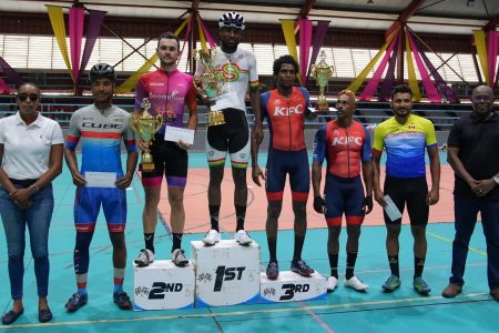 Britton John (centre) displays his spoils at the presentation ceremony at the National Gymnasium, Mandela Avenue, after sweeping the NSC Independence 3-Stage Cycling Road Race. Also in the photo (from left to right) are: NSC Commissioner Cristy Campbell, Joryn Simpson (4th), Enrique De Comarmond (2nd), Cortis Dey (3rd), Robin Persaud (5th), Paul De Nobrega (6th), and Director of Sport Steve Ninvalle