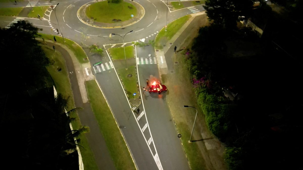 A car is set on fire, amid protests against plans to allow more people to take part in local elections in the French-ruled territory, which indigenous Kanak protesters reject, in Noumea, New Caledonia May 18, 2024 in this screengrab from video obtained by Reuters. Video Obtained by Reuters/via REUTERS