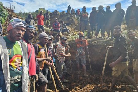 A locals gather amid the damage after a landslide in Maip Mulitaka, Enga province, Papua New Guinea May 24, 2024 in this obtained image. Emmanuel Eralia via REUTERS