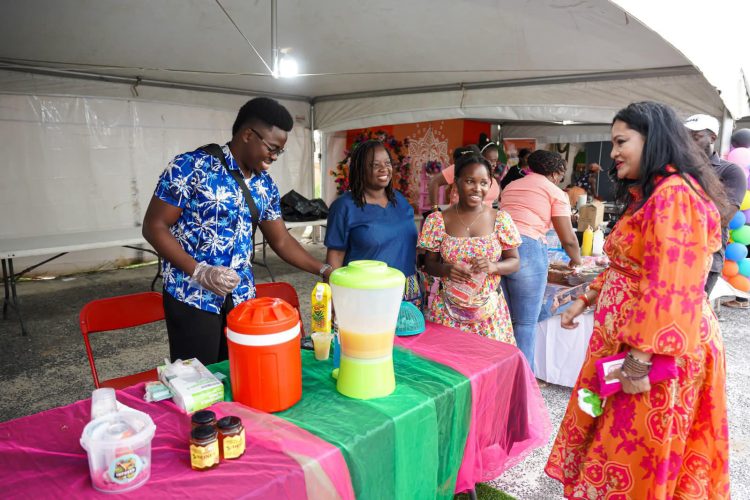 Minister Dr. Vindhya Persaud interacting with an exhibitor (Photo credit Ministry of Human  Services)