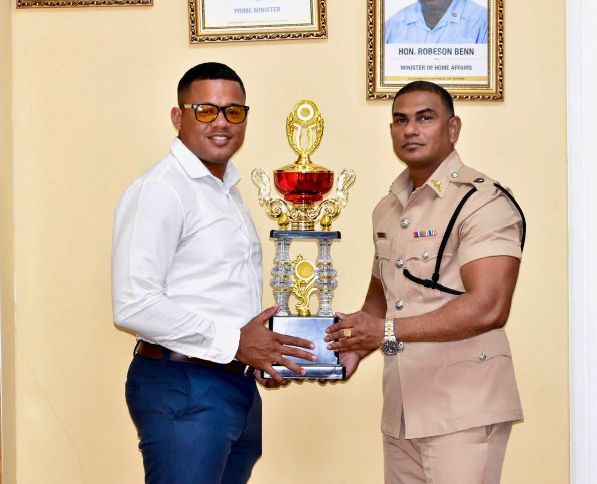 Divisional Commander #4B Krishna Ramana (right) presents the
championship trophy to tournament coordinator Troy Van Rossum
