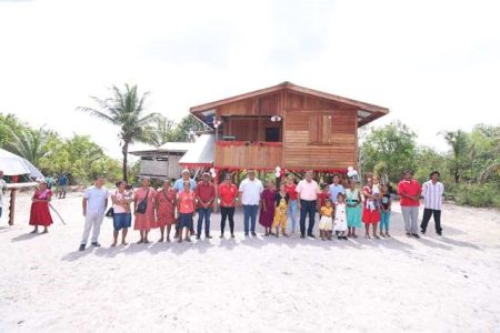 Beneficiaries in front of one of the houses (DPI photo)
