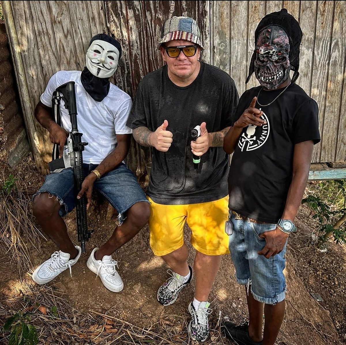 Canadian content creator and YouTuber Chris Must poses with members of a local gang. Instagram/Chris Must List