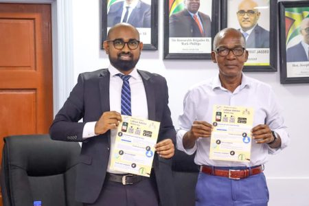 From right are Minister of Labour Joseph Hamilton and  Chief Labour Officer,  Dhaneshwar Deonarine (Ministry of Labour photo)