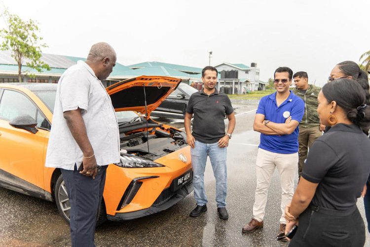 Prime Minister Mark Phillips (left) at the EV event yesterday. (Office of the Prime Minister photo)