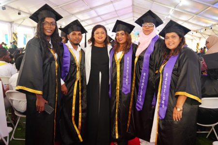 Minister of Education Priya Manickchand (3rd from left) with some graduates under the GOAL programme.