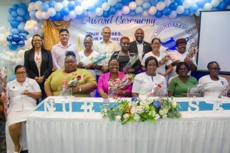 Senior health officials pose with the nurses who were awarded for their 30 or more years of service (DPI photo)