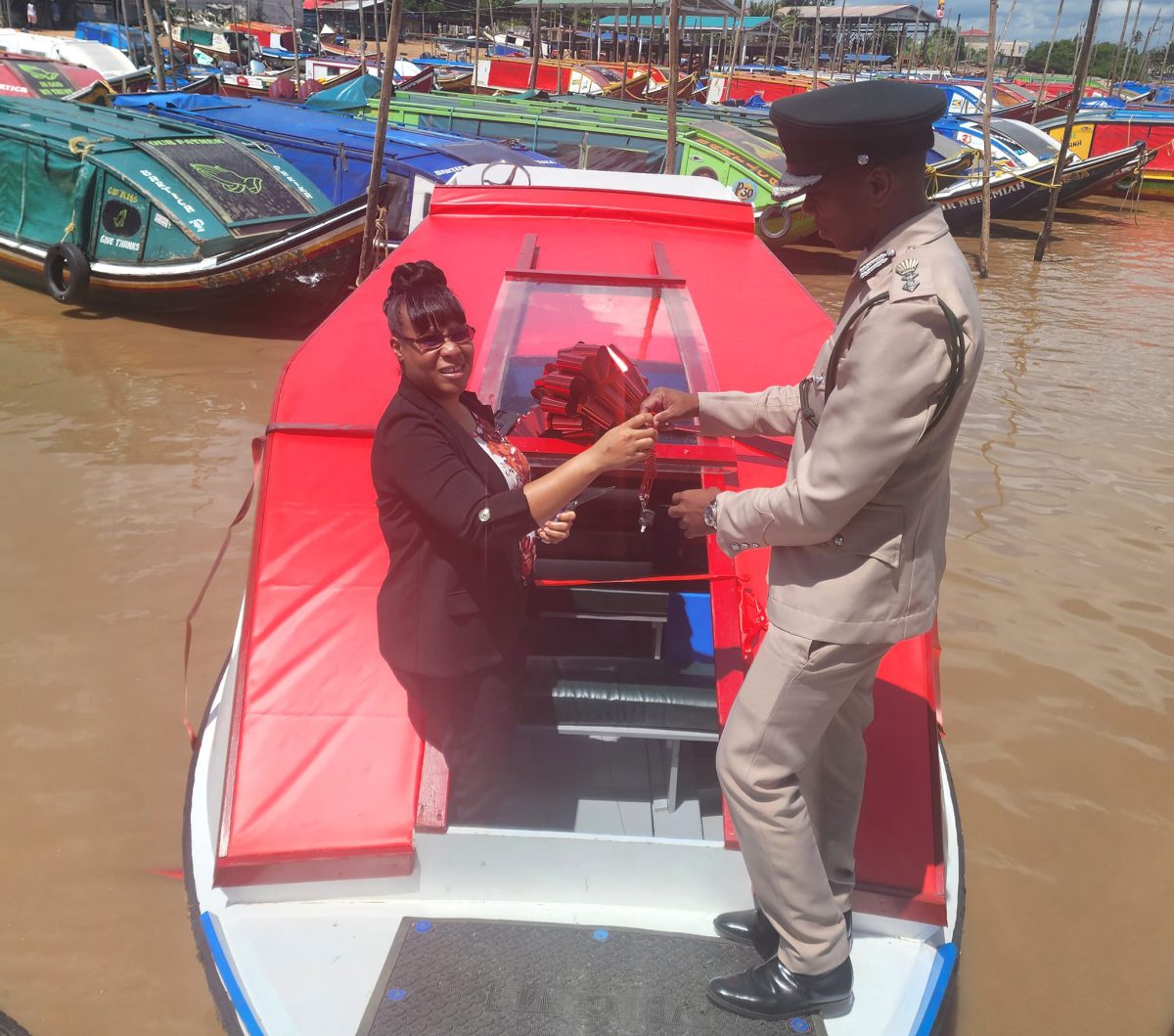 Permanent Secretary of the Ministry of Legal Affairs, Adele Diane Tricia Cole-Clarke (left) handing over the vessel to Director of Prisons, Nicklon Elliot. (Ministry of Home Affairs photo)