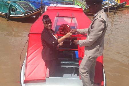 Permanent Secretary of the Ministry of Legal Affairs, Adele Diane Tricia Cole-Clarke (left) handing over the vessel to Director of Prisons, Nicklon Elliot. (Ministry of Home Affairs photo)