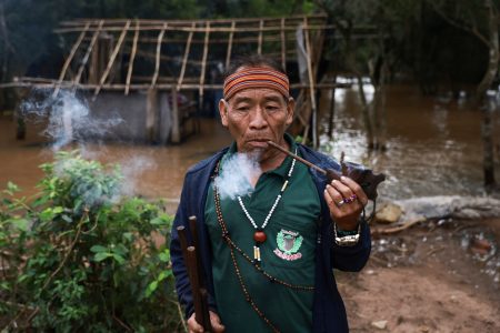 Timoteo Karai, cacique of Mbya Guarani, smokes as the Pindo Poty community is isolated due to flooding in the extreme south of Porto Alegre, Rio Grande do Sul, Brazil, May 18, 2024. REUTERS/Diego Vara