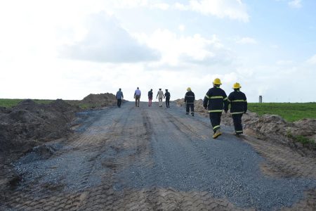 Minister of Home Affairs Robeson Benn  (second from left) inspecting the area with fire service officials. (Ministry of Home Affairs photo)
