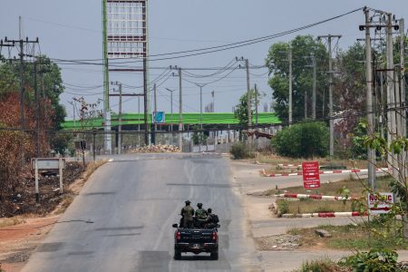 FILE PHOTO: Soldiers from the rebel Karen National Liberation Army (KNLA) patrol on a vehicle next to an area destroyed by the Myanmar military's airstrike in Myawaddy, the Thailand-Myanmar border town, April 15, 2024. REUTERS/Athit Perawongmetha//File Photo