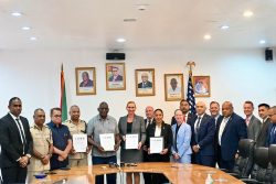 MoU signed: Home Affairs Minister Robeson is fifth from left, US Ambassador Nicole Theriot is sixth from left. (Ministry of Home Affairs photo)