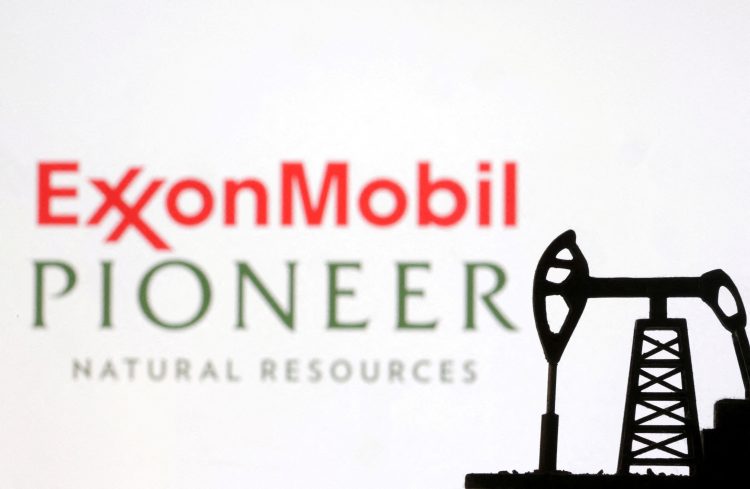 FILE PHOTO: ExxonMobil and Pioneer Natural Resources logos are seen in this illustration taken, October 8, 2023. REUTERS/Dado Ruvic/Illustration/File Photo