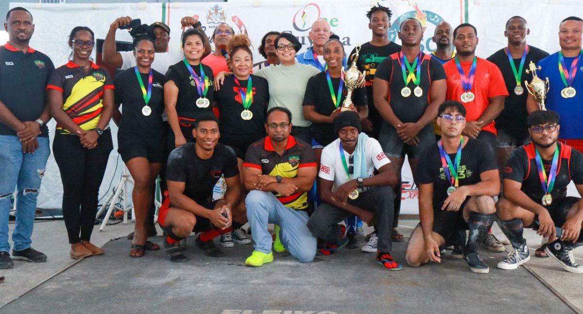 Athletes and officials of the GAPLF pose for a photo opportunity with Minister, Susan Rodrigues.