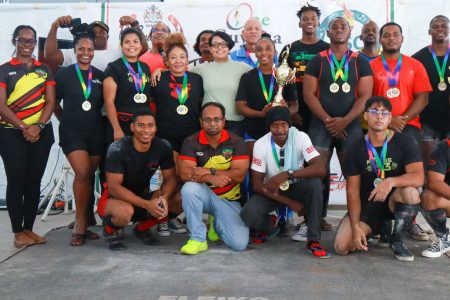 Athletes and officials of the GAPLF pose for a photo opportunity with Minister, Susan Rodrigues.