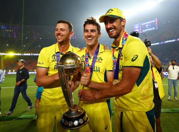 FILE PHOTO: Cricket - ICC Cricket World Cup 2023 - Final - India v Australia - Narendra Modi Stadium, Ahmedabad, India - November 19, 2023 Australia's Josh Hazlewood, Pat Cummins and Mitchell Starc celebrate with the trophy after winning the ICC Cricket World Cup REUTERS/Andrew Boyers/File Photo