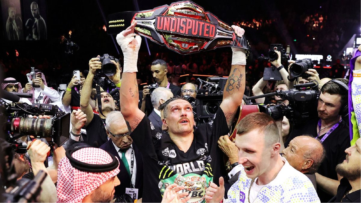 Joy! Oleksandr Usyk (centre) celebrates after defeating Tyson Fury to become the undisputed heavyweight champion