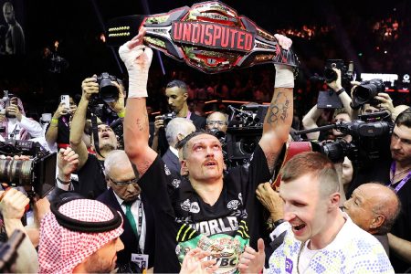 Joy! Oleksandr Usyk (centre) celebrates after defeating Tyson Fury to become the undisputed heavyweight champion