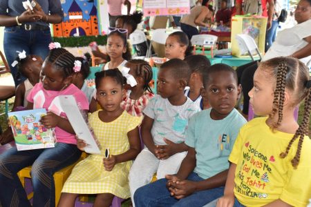The Department of Education, Region 10 has extended gratitude for the unwavering support at the second annual Reading by the Riverside Activity, held on April 28, 2024, at the “I love Linden” sign. In this Ministry of Education photo, children pay rapt attention.
