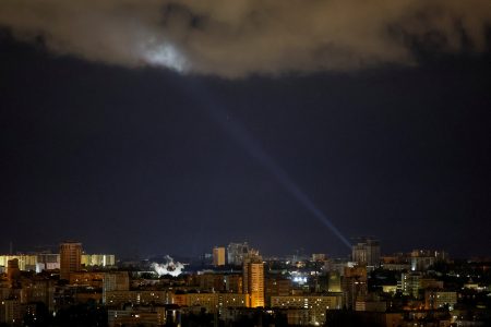 Ukrainian servicemen use a searchlight as they search for drones in the sky over the city during a Russian drone and missile strike in Kyiv, Ukraine May 8, 2024. REUTERS/Gleb Garanich