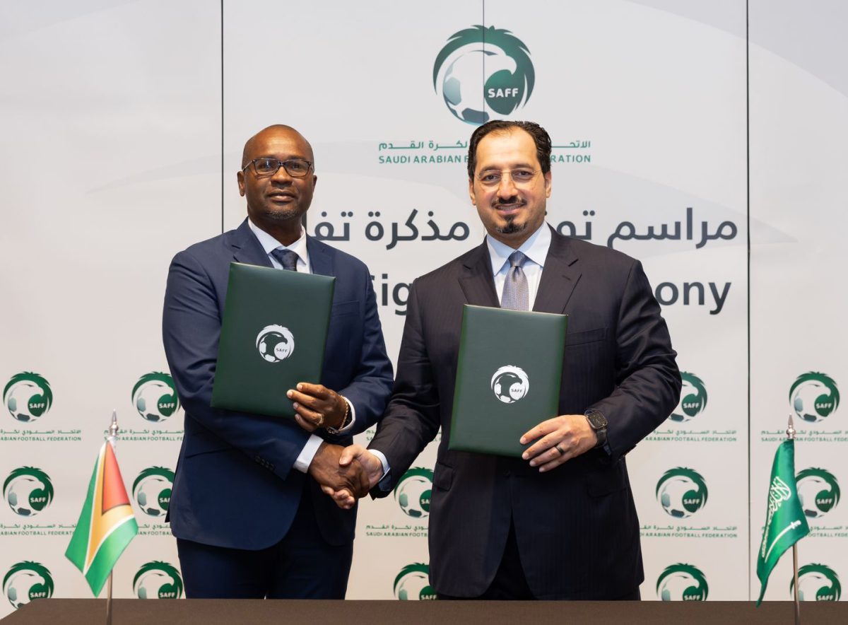 Wayne Forde, President of the GFF (left) and Yasser Al Misehal, President of the SAFF pose after the signing of the MoU