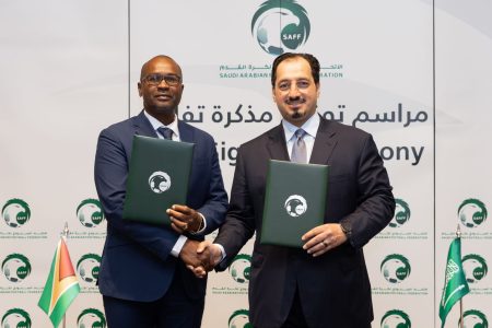 Wayne Forde, President of the GFF (left) and Yasser Al Misehal, President of the SAFF pose after the signing of the MoU