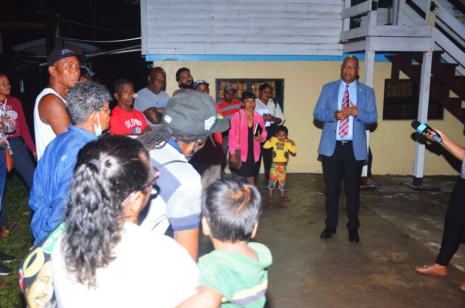 Minister of Public Works, Juan Edghill (right) met yesterday with residents of Silver Hill, Soesdyke-Linden Highway to address the deplorable state of the community’s main access road. During the engagement residents were assured that the  thoroughfare will be rehabilitated and an alternate route is being explored for truckers fetching loam from the area. (Department of Public Information photo)