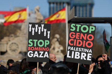 People hold anti-war placards during a protest to call for a ceasefire in Gaza to mark 100 days since the start of the conflict between Israel and the Palestinian Islamist group Hamas, in Madrid, Spain, January 20, 2024. REUTERS/Isabel Infantes/File Photo