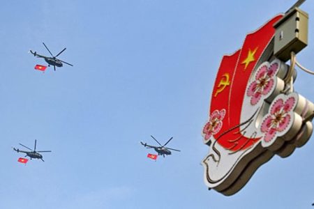 Helicopters with Vietnamese and Communist flags fly above Dien Bien Phu city on May 5, 2024, as Vietnam prepares to commemorate the 70th anniversary of the victory against French colonial forces. — AFP pic