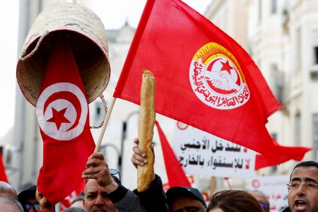 FILE PHOTO: A person holds up a baguette as supporters of the Tunisian General Labour Union (UGTT) protest against President Kais Saied, accusing him of trying to stifle basic freedoms, including union rights, in Tunis, Tunisia March 4, 2023. REUTERS/Zoubeir Souissi/File Photo