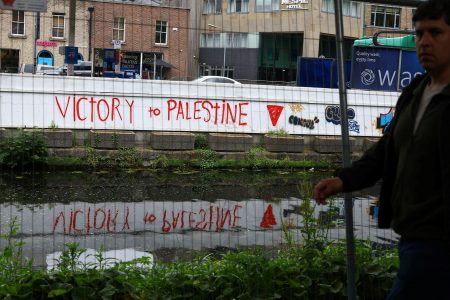 A man walks past graffiti reading ‘Victory to Palestine’ after Ireland has announced it will recognise a Palestinian state, in Dublin, Ireland, May 22, 2024. REUTERS/Hannah McKay