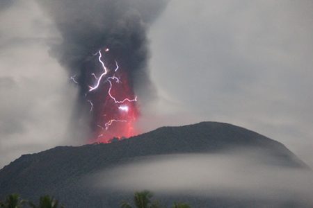 Lightning appears amid a storm as Mount Ibu spews volcanic material during an eruption, as seen from Gam Ici in West Halmahera, North Maluku province, Indonesia, May 18, 2024 in this handout image. The Center for Volcanology and Geological Hazard Mitigation (PVMBG)/Handout via REUTERS 
