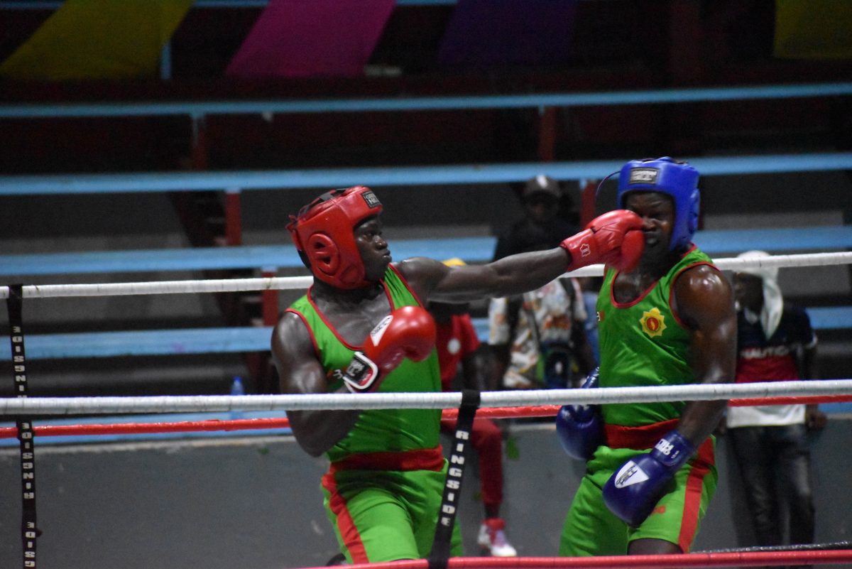 Rocked! Omari Bentham (left) delivers a brutal left hook to the head of Shawn Cudjoe
