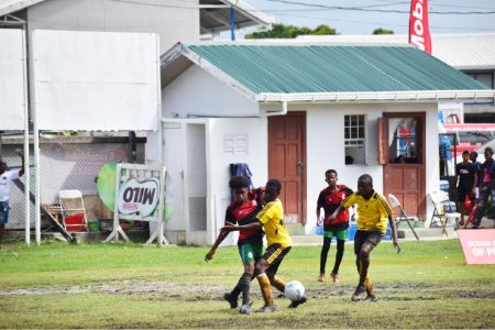 Flashback! Action in the earlier stages of the ExxonMobil U14 Boys and Girls Schools Football Tournament at the Ministry of Education Ground, Carifesta Avenue.
