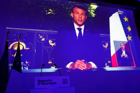 French President Emmanuel Macron appears on a screen following results after the polls closed in the European Parliament elections, in Paris, France, June 9, 2024.